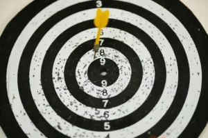 A dart strikes the bullseye of a dartboard, showcasing precision and skill in the game.